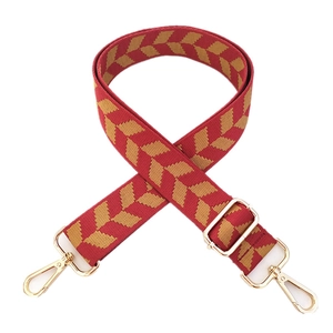 Adjustable red woven crossbody bag strap with chevron pattern and gold metal buckles