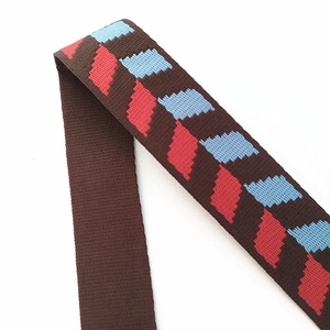 Detail of adjustable woven bag strap showing high-density nylon texture and zigzag pattern