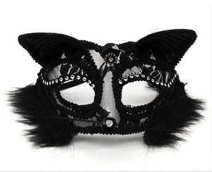 Close-up of black lace cat mask featuring feather trim and sparkling rhinestone details