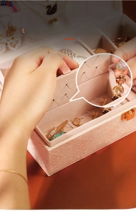 Detail of PU leather jewelry box featuring earring studs plate and tiered storage