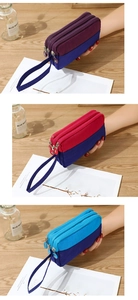 Close-up of three-layer nylon wristlet bags with secure zippers and wrist straps