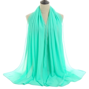 Mint green chiffon bubble shawl scarf for women on mannequin with elegant draping effect
