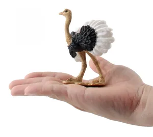 Detailed view of a miniature ostrich figurine shown in palm for size comparison