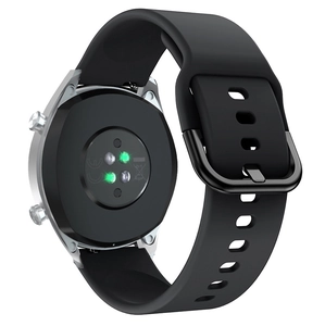 Close-up of smart watch back with green heart rate sensor and black silicone strap