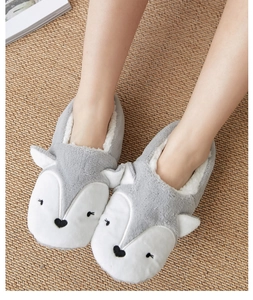 Close-up of fluffy grey fox non-slip thermal socks with warm faux fur lining
