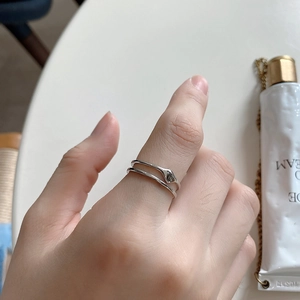 Detail of 925 sterling silver double-layer geometric ring on model's finger
