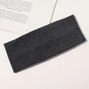 Detailed view of the dark grey ribbed knit headband showing soft elastic texture