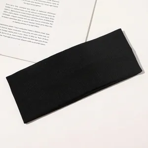Close-up of black ribbed knit yoga headband with high elasticity and soft texture