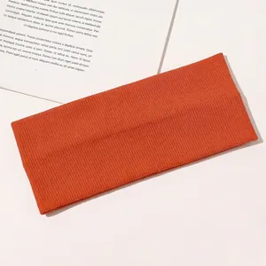 Detail view of the caramel orange ribbed cotton yoga headband with fine knit texture