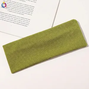 Detail of green ribbed knit yoga headband showing premium moisture-wicking fabric texture