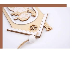 Macro detail of wooden Christmas tree ornament featuring laser-cut snowman and rustic rope