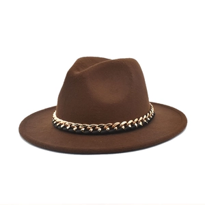 Detail shot of the gold and black chain accent on a dark brown wool fedora hat