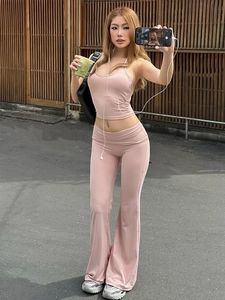 Pink two-piece set with halter neck crop top and high-waisted flare yoga pants for women