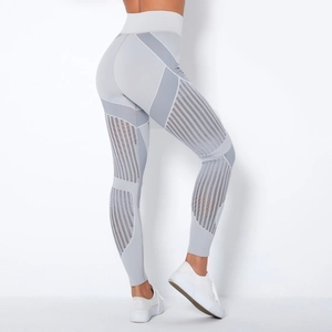 Close-up of grey high-waisted seamless leggings featuring striped mesh panels for breathability