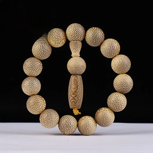 Close-up of 15mm dragon blood gold bamboo beads with natural snake-like wood grain textures
