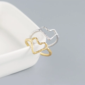 Detail showing gold and silver S925 heart rings with irregular foil texture on edges