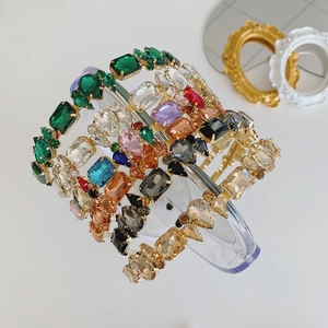 Detailed close-up of Baroque style hairbands with colorful crystals on gold metal alloy base