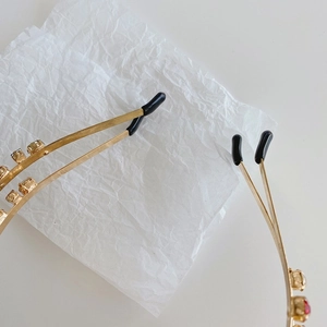 Macro detail of gold double-row headband with colorful rhinestones and soft protective tips