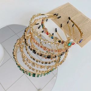 Detail of baroque alloy headbands with multi-color rhinestones on a mirror surface