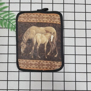 Detailed close-up of a thick cotton oven mat with a horse art print and hanging loop