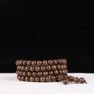 Detail of 6mm 108 sandalwood prayer beads with fine grain and polished finish