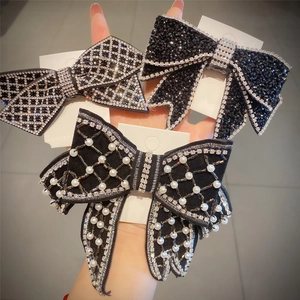 Detail of handmade black velvet hair clips with pearls and rhinestones on cards
