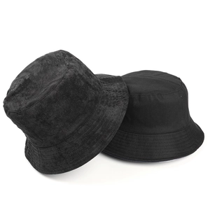 Macro detail of black reversible bucket hat showing corduroy and cotton textures