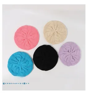Detailed top view of cable knit berets in pink, beige, blue, black, and purple colors