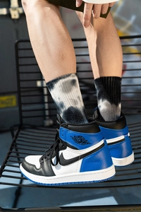 Detail of tie-dye cotton mid-calf socks in black and white pattern on a model