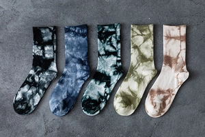 Top view of five pairs of tie-dye cotton crew socks in assorted street style colors