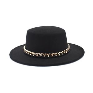 Close-up of a black wool felt gambler hat featuring a bold gold chain band detail
