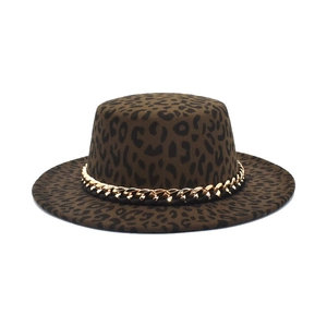 Detail of leopard print boater hat featuring a chunky gold metal chain on dark wool felt