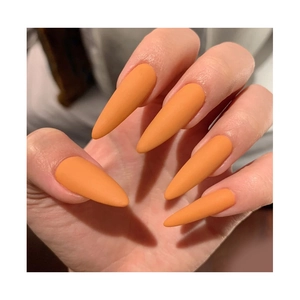 Matte orange long stiletto press-on nails shown on hand for a professional salon look