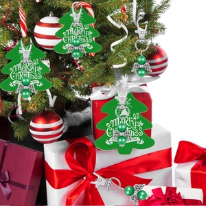 Detail of Christmas tree pendant with angel wings, beads and festive greeting tag