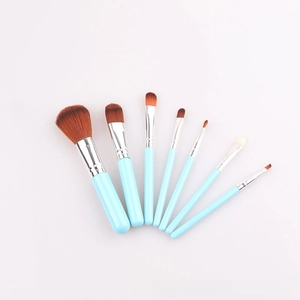 Detail view of 7-piece light blue makeup brush set with silver ferrules on white background
