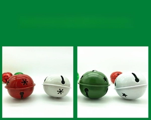 Close-up of 50mm metal Christmas bells with snowflake and star cutout patterns