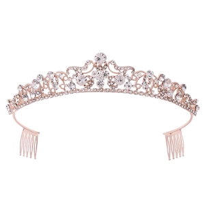 Luxurious rose gold bridal crown with crystals and hair combs on a white background