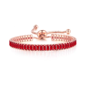 Detail of rose gold tennis bracelet with red rectangular zircons and adjustable slider