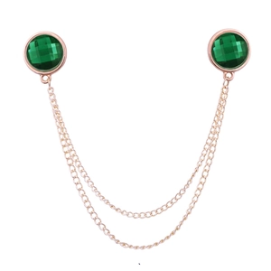 Golden double chain collar pin with faceted green gemstones on a clean white background