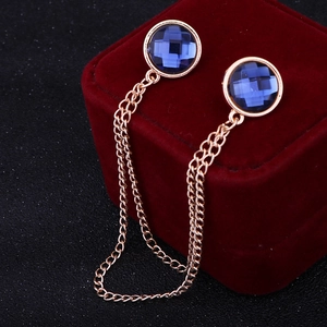 Detail of rose gold collar chain with blue crystals on a red velvet jewelry box