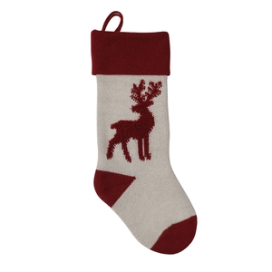 Close-up of a knitted Christmas stocking with a red reindeer pattern and hanging loop