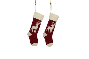 Close-up of red and white knitted Christmas stockings with reindeer patterns
