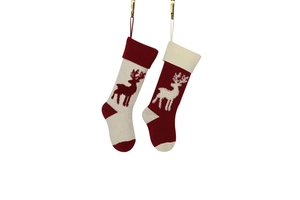 Detail of red and white knitted Christmas stockings with reindeer patterns and hanging loops