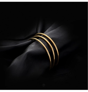 Minimalist polished gold triple-ring bangle set made of durable titanium steel