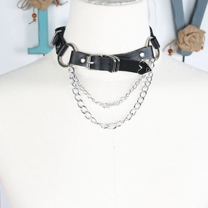 Detail of gothic leather choker with layered silver chains and heart-shaped metal pendant