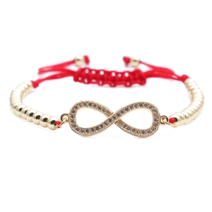 Red braided cord infinity bracelet with gold metal beads and sparkling zircon stones