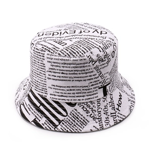 Retro newspaper print bucket hat for women in stylish black and white cotton design