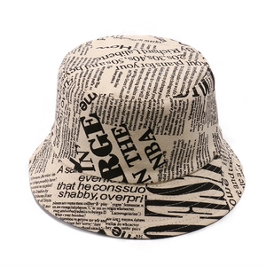 Detail shot of newspaper print canvas bucket hat with black letters on beige fabric