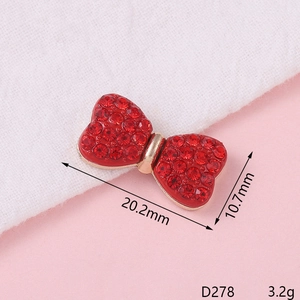 Macro shot of red rhinestone bow pendant with dimensions 20.2mm x 10.7mm for DIY crafts
