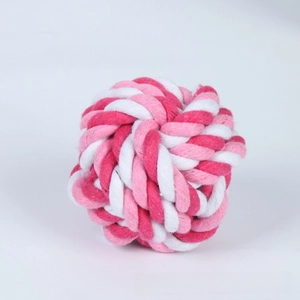 Detail of pink and white braided cotton rope ball toy for dog teeth cleaning and play